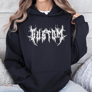 May include: Black hoodie with the word "CUSTOM" in a white, stylized, gothic font across the chest. The hoodie has a drawstring hood and a front pocket. The word "BLACK" is printed in a white, bold font at the bottom right.