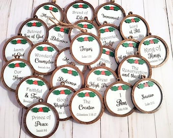 May include: A collection of round wooden Christmas ornaments with various religious phrases in black text on a white background. Each ornament has a brown wooden frame and is decorated with a green holly and red berry design.