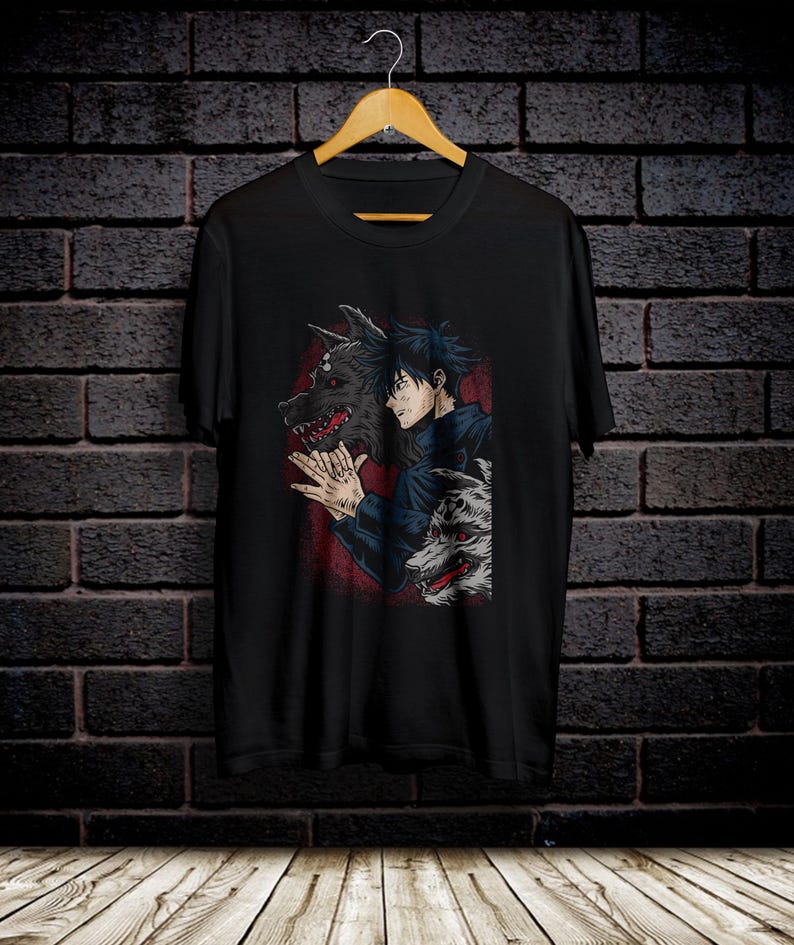 May include: Black t-shirt with a graphic print of a man with a wolf's head. The wolf's head is partially obscured by the man's hair. The man is wearing a dark blue jacket and has a serious expression on his face.