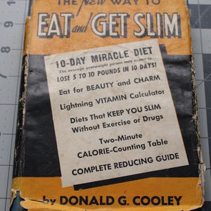 May include: Vintage book titled "The New Way to Eat and Get Slim" with a yellow and black cover. The book features a white insert with text about a 10-day miracle diet, including losing 5 to 10 pounds. The author's name, Donald G. Cooley, is also visible.