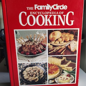 May include: A red cookbook titled "The Family Circle Encyclopedia of Cooking." The cover features a collage of food images, including a roast with cherries, pasta, bread, and desserts. White text is used for the title.