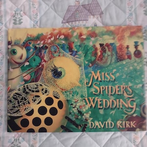 May include: A hardcover children's book titled Miss Spider's Wedding by David Kirk. The cover features a yellow spider with black spots wearing a white lace veil, surrounded by various colorful insect characters in a garden setting.