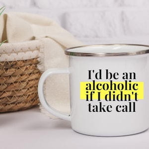 May include: White enamel mug with a black and yellow design. The text on the mug reads "I'd be an alcoholic if I didn't take call".
