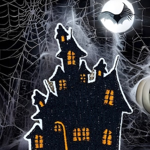 May include: A black felt Halloween haunted house patch with orange windows and a white outline. The patch is set against a black background with a spider web and a full moon.