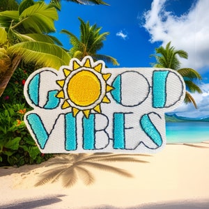May include: White embroidered patch with a blue and yellow sun and the text "GOOD VIBES".