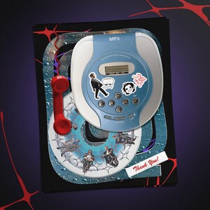 May include: A light blue and white MP3 player featuring a small digital display, circular control buttons, and several small stickers. A bright red telephone handset is attached to the side. A white rectangular label with the text Thank You! is visible.