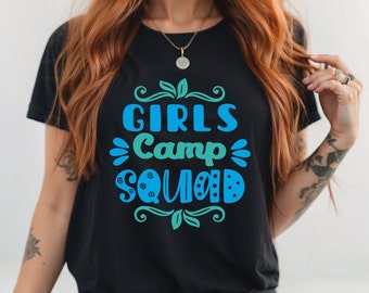 May include: Black t-shirt with a blue and green graphic that says "Girls Camp Squad" with decorative swirls and leaves.