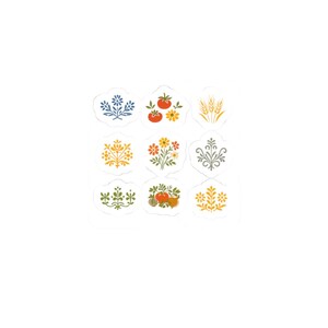 May include: Nine decorative stickers with various floral and fruit designs. The stickers feature images of blue flowers, tomatoes, wheat, yellow flowers, and other botanical elements. The stickers are in a variety of colours, including yellow, orange, and green.
