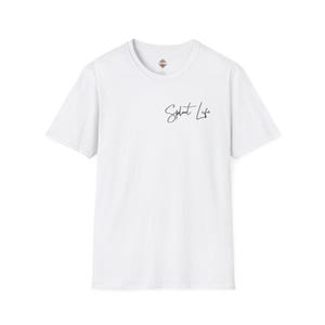May include: White t-shirt with short sleeves and a crew neck. The shirt has the text "Splout Life" written in black cursive on the front.
