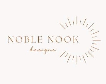 May include: Logo for Noble Nook Designs, featuring the text "NOBLE NOOK designs" in a simple, modern font. The logo is centered on a white background and features a stylized sunburst design in a brown color.