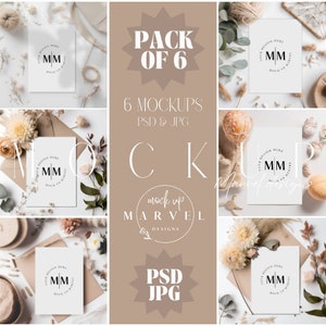 May include: A set of six mockup cards with a neutral color scheme. The cards are surrounded by dried flowers, pampas grass, and other natural elements. The cards feature a simple circle design with the text "MM" in the center. The text "Pack of 6" and "6 Mockups PSD & JPG" are also visible in the image.