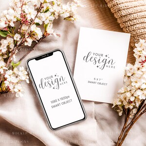 May include: A smartphone and a 5x7 inch card mockup with the text "Your Design Here" and "Smart Object". The phone screen displays 1080 x 1920px. White flowers and a beige knitted item are in the background.