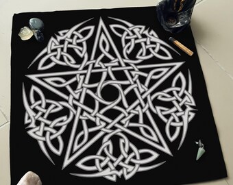 May include: A black cloth with a white pentagram design. The pentagram is made of a series of interwoven knots. The cloth is surrounded by various crystals and a small incense burner.