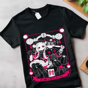 May include: Black t-shirt with a white and pink graphic print of two anime characters. The characters are a girl with long hair and a boy with short hair. The text on the shirt reads "地縛少年花子くん".