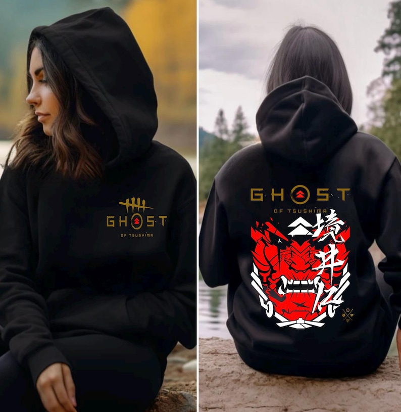 May include: Black hooded sweatshirt with a gold "Ghost of Tsushima" logo on the front and a red and white samurai mask with Japanese characters on the back.