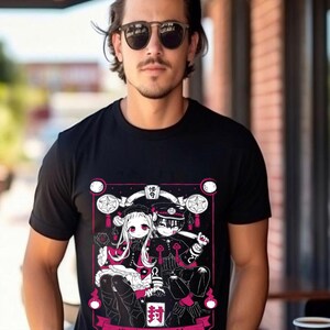May include: Black t-shirt with a white and pink graphic print of two anime characters. The characters are sitting on a throne with a pink background. The text "地縛少年花子くん" is printed below the characters.