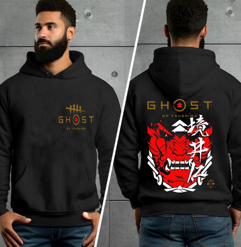 May include: Black hooded sweatshirt with a gold "Ghost of Tsushima" logo on the front and a red and white samurai mask with Japanese characters on the back.