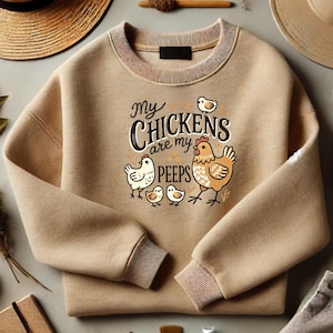 May include: A tan sweatshirt with a graphic print of chickens and the text "My Chickens are my peeps".