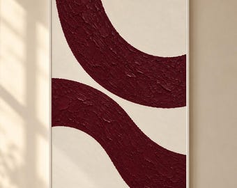 May include: A rectangular wall art piece in a white frame featuring two thick, textured, deep burgundy curved lines painted against a smooth off-white background. The paint application is heavy and creates a raised, tactile surface.