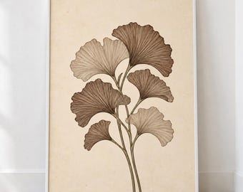May include: A framed wall art print featuring a botanical illustration of ginkgo biloba leaves. The leaves are rendered in varying shades of brown with fine line details, set against a solid, light beige, textured paper background.