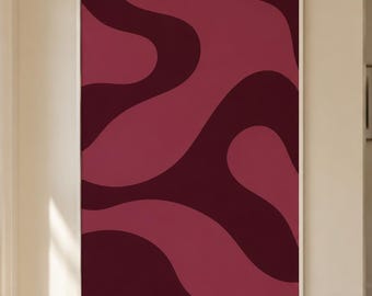 May include: A rectangular wall art piece featuring a series of fluid, organic shapes in varying shades of deep burgundy and muted rose pink. The artwork is enclosed within a thin, light-colored frame and hangs vertically on a plain wall.