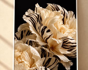 May include: A framed wall art print featuring a close-up of cream-colored peony-like flowers with distinct black tiger-stripe patterns on the petals, set against a solid black background within a thin white frame.