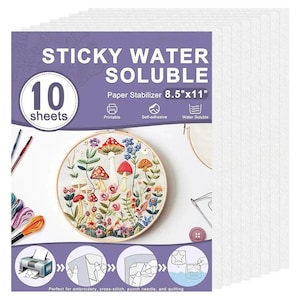 May include: A pack of 10 sheets of sticky water-soluble paper stabilizer measuring 8.5 inches by 11 inches. The packaging features a purple header with white text, an embroidery hoop with a mushroom design, and diagrams showing printing and use.