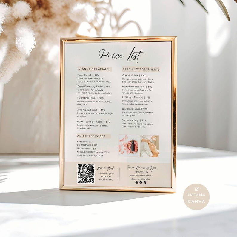 A facials price list in a gold frame. It is on top of a marble table. There are some Pampas grasses to the top left of the frame. There are shadows coming in from the window.