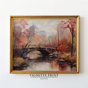 May include: A painting of a bridge over a river in a park with fall foliage and buildings in the background.