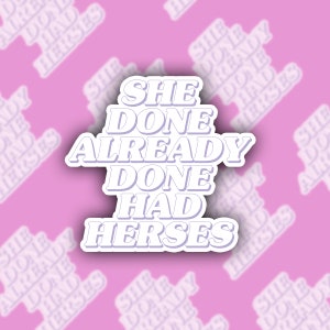 May include: A white sticker with the text "She Done Already Done Had Herses" in a purple font. The sticker is on a pink background with a repeating pattern of the same text.