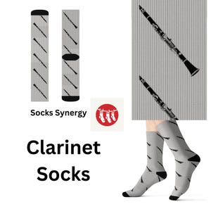 May include: A pair of gray socks with a black clarinet design. The socks are shown on a model's feet. The socks are also shown as a flat lay with the text "Socks Synergy" and "Clarinet Socks".