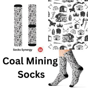 May include: Coal mining socks with a black and white pattern of mining tools and equipment. The socks have black heels and toes. The words "Coal Mining Socks" are printed in large black letters.