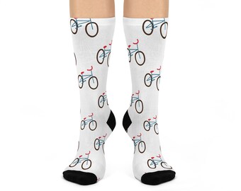 May include: White socks with a repeating pattern of small blue bicycles with red handlebars. The socks have black heels and toes. These socks are a fun accessory for any outfit.