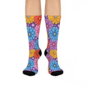 May include: A pair of colourful socks with a floral pattern. The socks are purple, blue, orange and yellow. The flowers are stylised and have a cartoonish look.