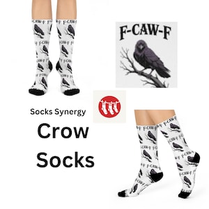 May include: White crow socks with a black crow and branch design. The socks have the text "F-CAW-F" and are part of the "Crow Socks" collection. The image also includes a crow illustration and the "Socks Synergy" logo.