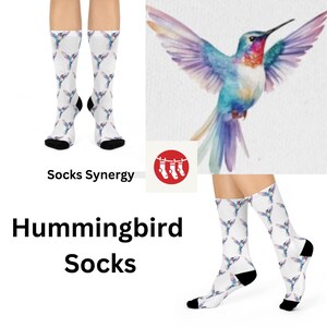 May include: A pair of white socks with a colorful hummingbird print. The socks are shown on a model's legs. The image also includes a close-up of a single hummingbird with a watercolor-like design. The text "Socks Synergy" and "Hummingbird Socks" is also included in the image.