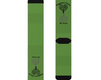 May include: A pair of green socks with a black and grey tree design. The tree is shaped like a heart and the text "Happiness Grows On Trees" is printed on the socks.