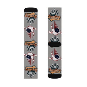 May include: Gray socks with a black cuff, featuring bowling-themed graphics. The design includes bowling pins, bowling balls, and the word "Bowling" in an orange and blue banner. The socks have a repeating pattern.