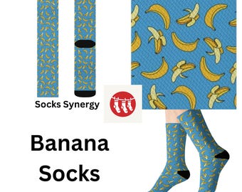 May include: Blue socks with a repeating pattern of yellow bananas. The socks have black heels and toes. The text "Socks Synergy" is printed on the socks. The words "Banana Socks" are printed in large black letters.