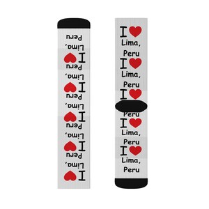 May include: A pair of white socks with a repeating pattern of red hearts and the text "I Lima, Peru".