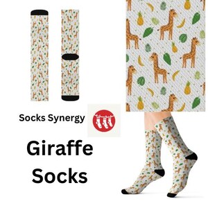 May include: Giraffe socks with a repeating pattern of giraffes, bananas, pineapples, and leaves on a white background. The socks have black heels and toes. The text "Giraffe Socks" is displayed below the image.