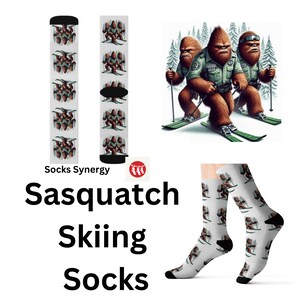 May include: White socks with a repeating pattern of a Sasquatch skiing, with a black heel and toe. The image also shows a Sasquatch illustration and the text "Sasquatch Skiing Socks".