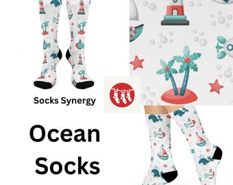 May include: A pair of white socks with a colorful ocean-themed design. The socks feature lighthouses, palm trees, whales, and sailboats. The socks are called "Ocean Socks" and are from "Socks Synergy".