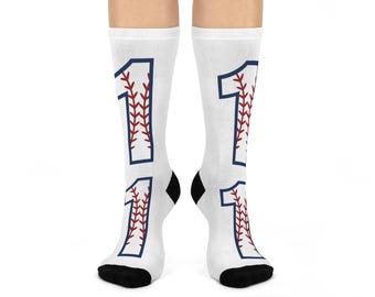 May include: White socks with a baseball-themed number one design. The number is outlined in blue and filled with red stitching.