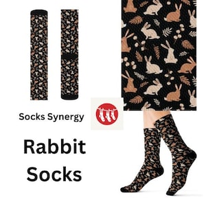 May include: A pair of black socks with a brown rabbit pattern. The socks are shown on a model's legs. The text "Socks Synergy" and "Rabbit Socks" is also shown in the image.