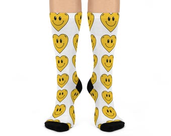 May include: White socks with a repeating pattern of yellow heart-shaped smiley faces.