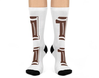 May include: White socks with a brown football-shaped number one on each sock. The number one is outlined in white and has stitching details.