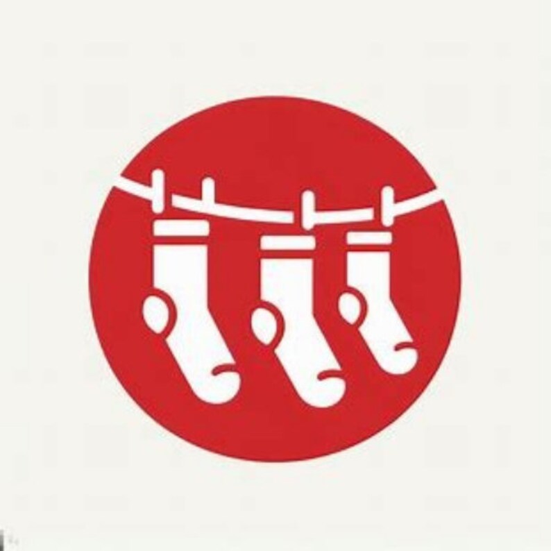May include: A red circle with a white line and three white socks hanging from it. The socks are depicted with a simple, minimalist design, suggesting a theme of laundry or clothing.