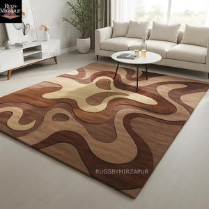 Earth-tone abstract rug in hand-tufted wool featuring sculptural high-low pile with flowing patterns in beige, brown, and caramel. Ideal for U.S. living rooms with neutral or modern organic decor.