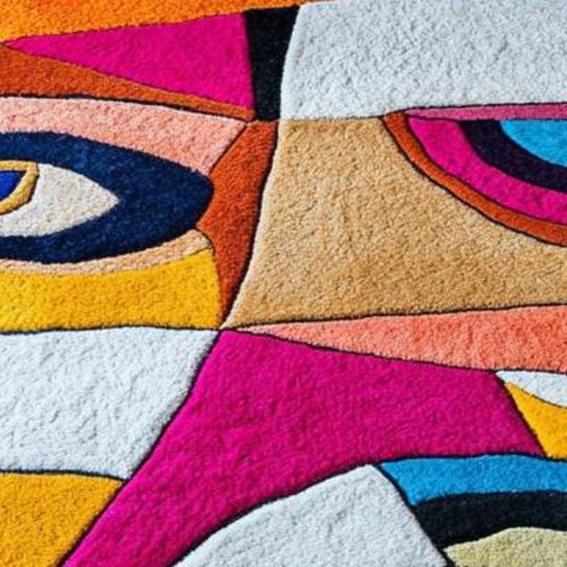 Vibrant handmade wool carpet by Rugs By Mirzapur with cubist-inspired faces and bold color blocks. Each rug is hand-tufted for a unique texture and soft finish. Perfect for living rooms, studios, and art-inspired interiors, this design adds character, warmth, and contemporary flair while celebrating modern craftsmanship.